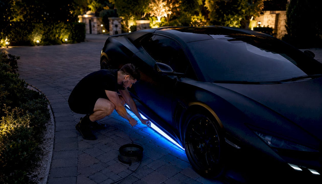 Person installing vehicle underglow lighting