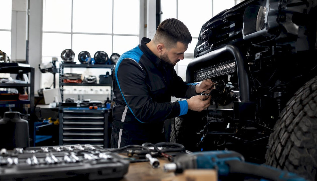 Technician inspecting vehicle LED wire harness