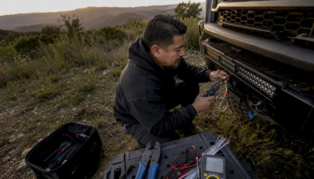 Mechanic wiring high-lumen truck lights in garage
