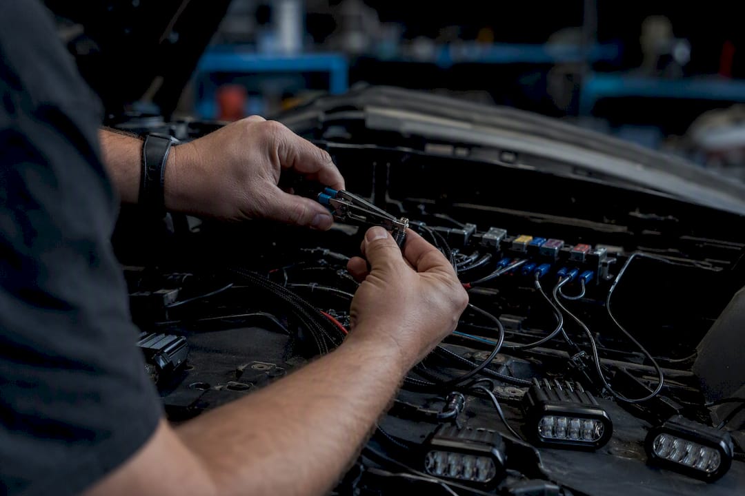 Hands wiring Can-Am rock lights in garage