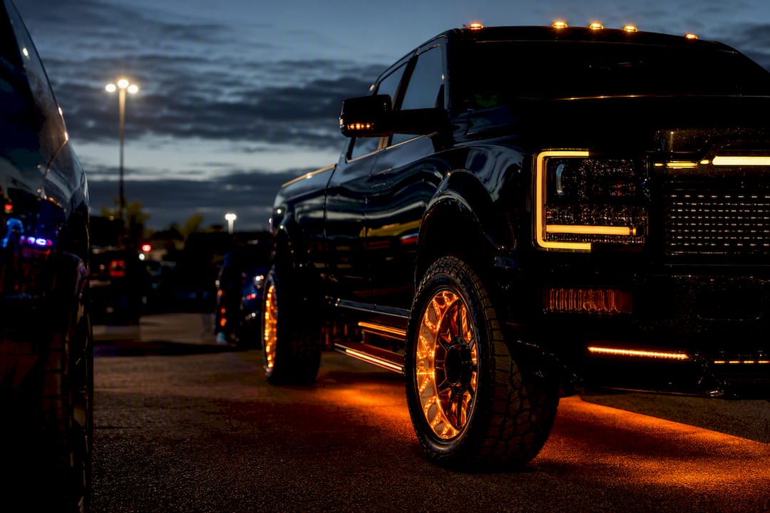 Layered truck lighting at an evening meet