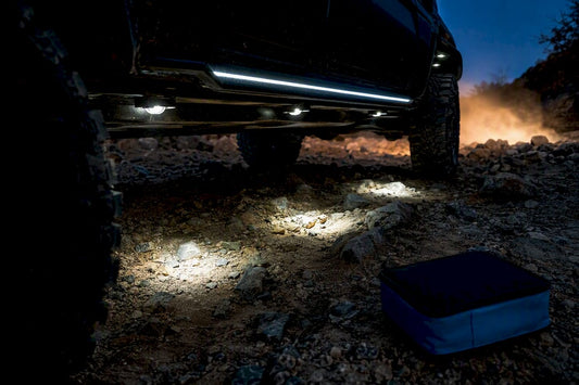 Rock lights and underglow illuminating rocky trail
