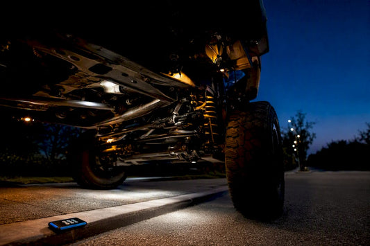 White and amber rock lights beneath vehicle