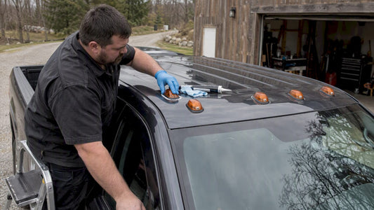 Owner sealing a pickup roof marker light